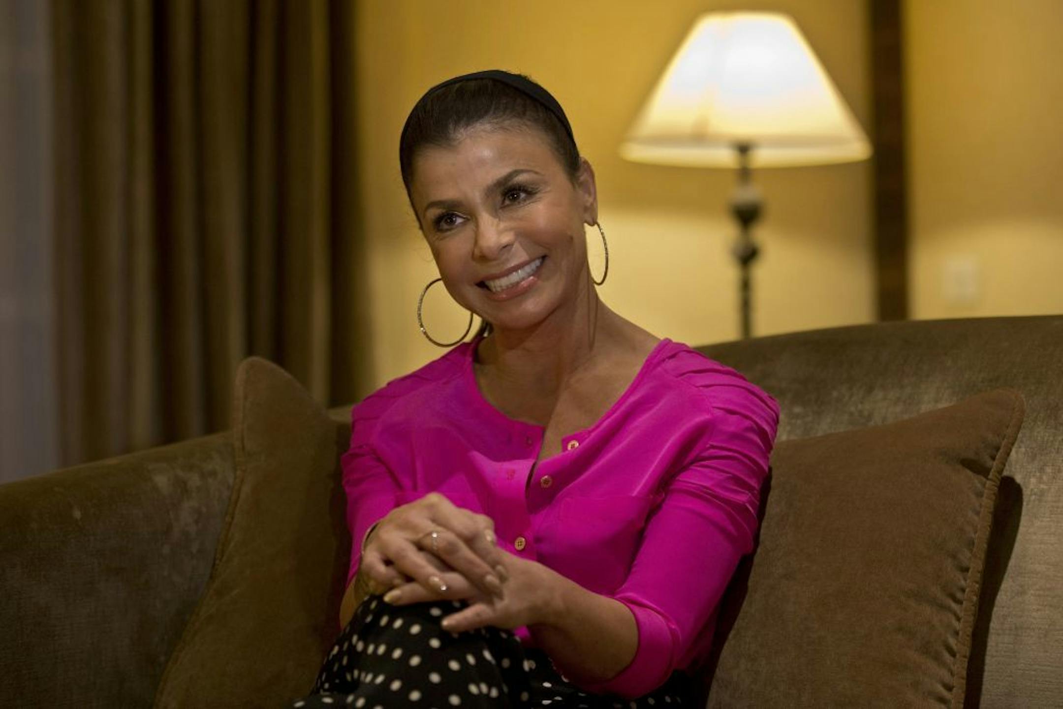 In this Thursday, Oct. 31, 2013 photo, singer, dancer, choreographer and TV personality Paula Abdul smiles during an interview with The Associated Press in Jerusalem. She's been an award-winning singer, dancer, choreographer and TV personality. Now Paula Abdul can add a new title to her resume - religious pilgrim. The former American Idol and X Factor judge is on her first trip ever to Israel, where she is connecting to her Jewish roots and planning on holding a belated Bat Mitzvah - the Jewish