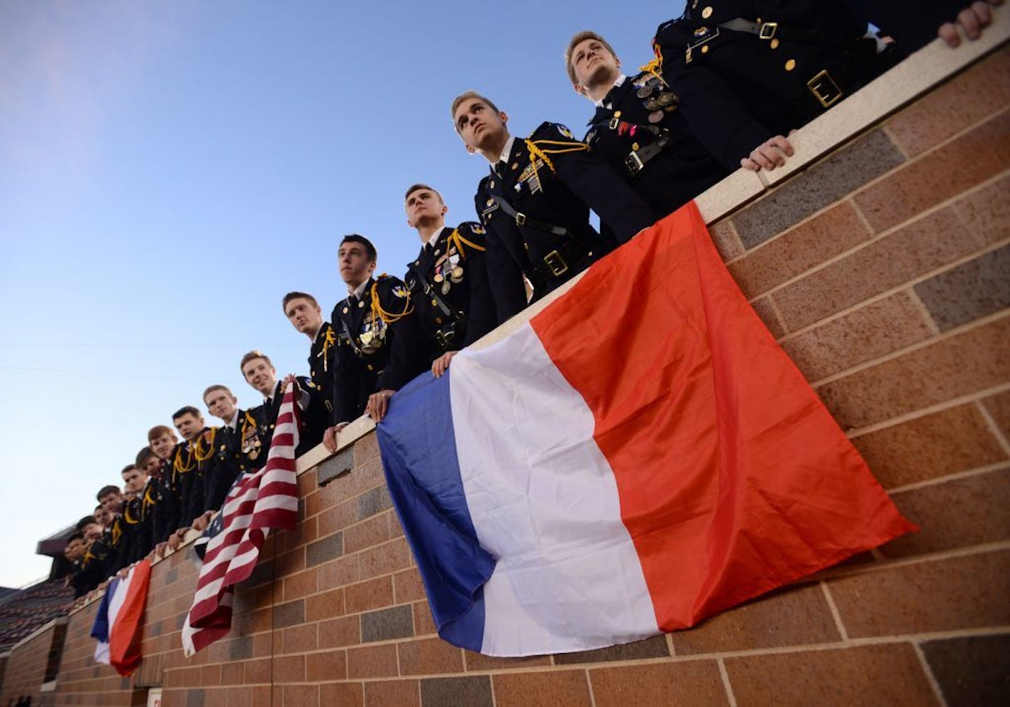 St. Thomas Academy students held up French and American flags during Saturday's 5A championship game against St. Michael-Albertville.