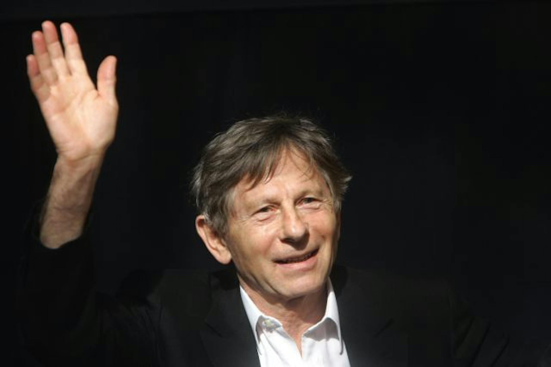 FILE - IN this French-born film director Roman Polanski waves during a media presentation in Berlin. The Swiss government says it will make an announcement Monday July 12, 2010 about Roman Polanski's extradition to the United States for a 1977 sex case. The government says Justice Minister Eveline Widmer-Schlumpf will hold a news conference in the capital Bern at 2 p.m. (1200 GMT; 8 a.m. EDT) "on the matter of the Roman Polanski extradition decision."