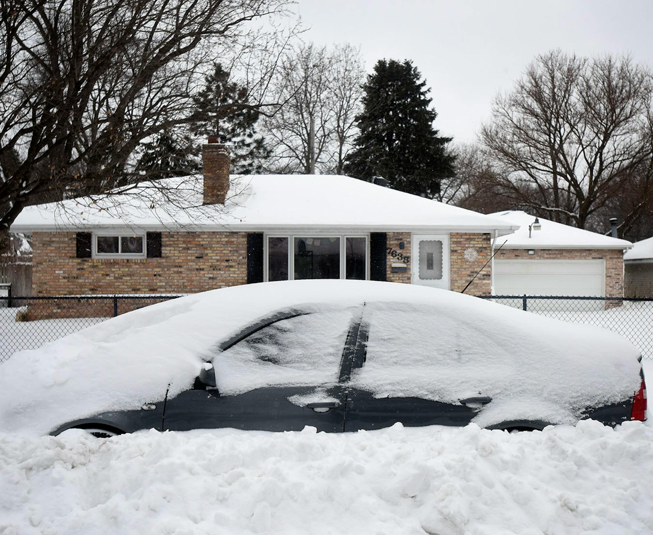 A car was buried behind a snow drift Sunday in Richfield.