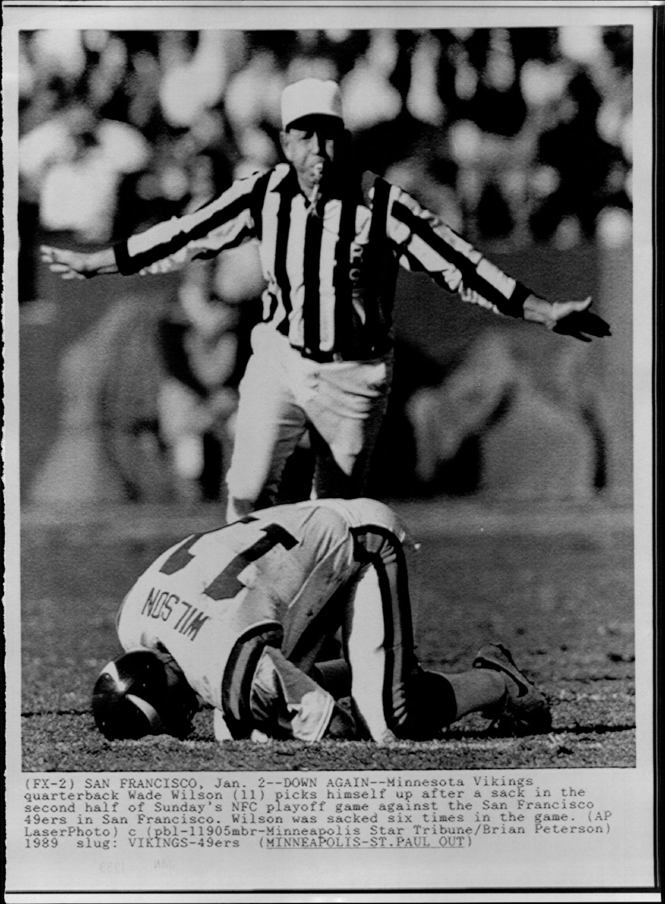 January 2, 1949 Down Again - Minnesota Vikings quarterback Wade Wilson (11) picks himself up after a sack in the second half of Sunday's NFC playoff game against the San Francisco 49ers in San Francisco. Wilson was sacked six times in the game. Brian Peterson, Minneapolis Star Tribune; AP Laserphoto