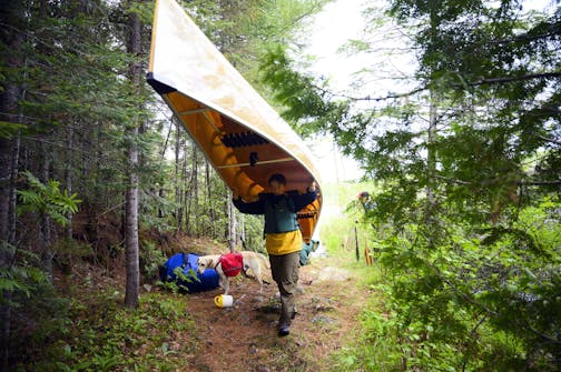 Aidan Jones portaged a canoe during one of the three portages from Mountain Lake to Moose Lake.