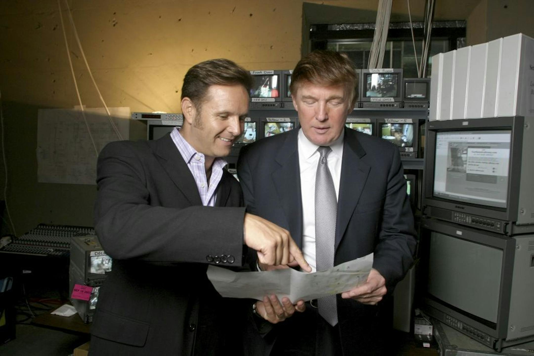 FILE -- Mark Burnett, creator and producer of the reality show "The Apprentice" with his star Donald Trump in the control room for the TV series at Trump Tower in New York, Sept. 22, 2003. Often met with scoffing disdain by wealthy elites and mainstream civic leaders, Trump delivered perhaps the greatest shock to the American political system in modern times.