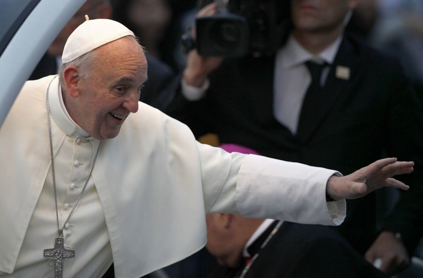 Pope Francis waves from his popemobile as he arrives for the Stations of the Cross event on Copacabana beach in Rio de Janeiro, Brazil, Friday, July 26, 2013.