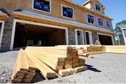 In this June 24, 2021 photo, lumber sits outside at a housing construction site in Middleton, Mass. 