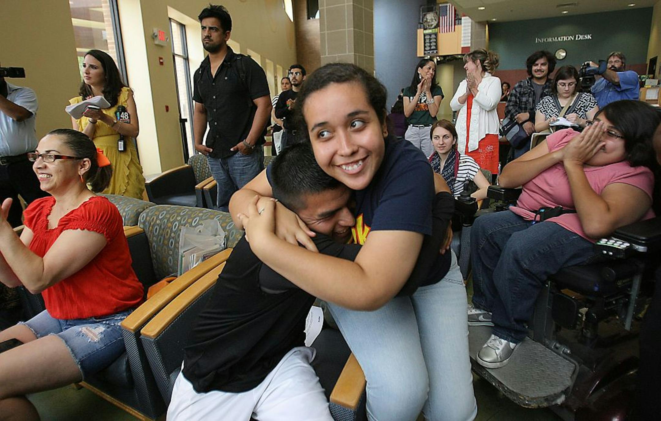 Maria Ibarra,19, originally from Durango Mexico and Candido Renteria, 24, of Monterrey Nuevo Leon, hug with joy after President Obama announced he would ease enforcement of immigration laws, Friday, June 15, 2012 in Edinburg, Texas. Many students gathered at the student union at the UTPA Campus in Edinburg to watch the annoucement. (AP Photo/The Monitor, Delcia Lopez) MAGS OUT; TV OUT