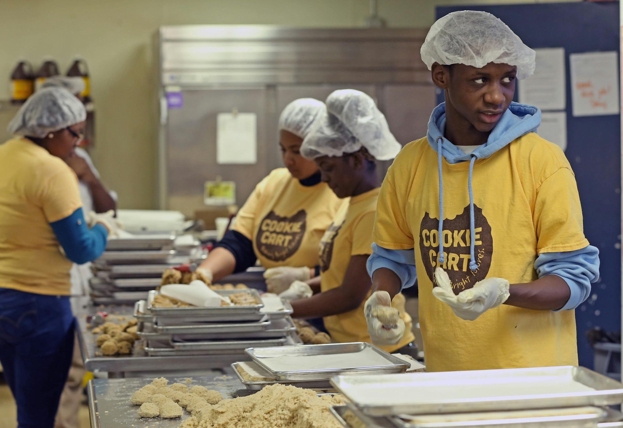 (right) Omar Pope made coconut cookies at the Cookie Cart on 2/6/14. The Cookie Cart is a fixture of north Minneapolis, a program that teaches high-school kids bakery and life skills. Photographed on 2/6/14.] Bruce Bisping/Star Tribune bbisping@startribune.com Omar Pope/source.
