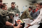 From the left, Brad Rixmann, Spc. Deanna Rice and Sgt. Banshee Barnett, Spc. Richard Polson and others packed boxes of gifts for soldiers overseas.