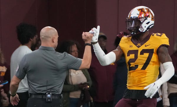 Head coach P.J. Fleck and defensive back Tyler Nubin shared a special handshake during the Gophers spring football game on Saturday.