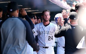 The Rockies' Ryan McMahon is congratulated after hitting a two-run homer off Phillies pitcher Ranger Suárez in the first inning Sunday in Denver.