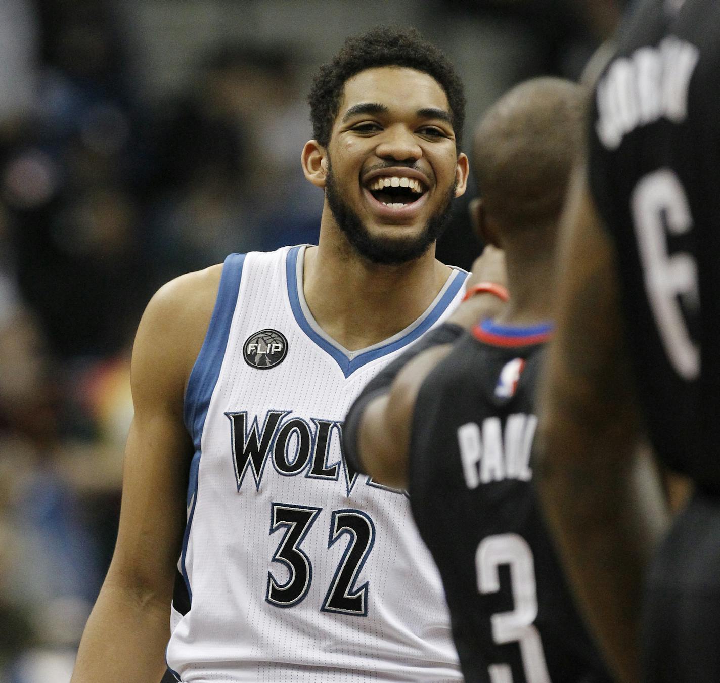 Minnesota Timberwolves center Karl-Anthony Towns (32) laughs with Los Angeles Clippers guard Chris Paul (3) before an NBA basketball game in Minneapolis, Wednesday, March 30, 2016. (AP Photo/Ann Heisenfelt)