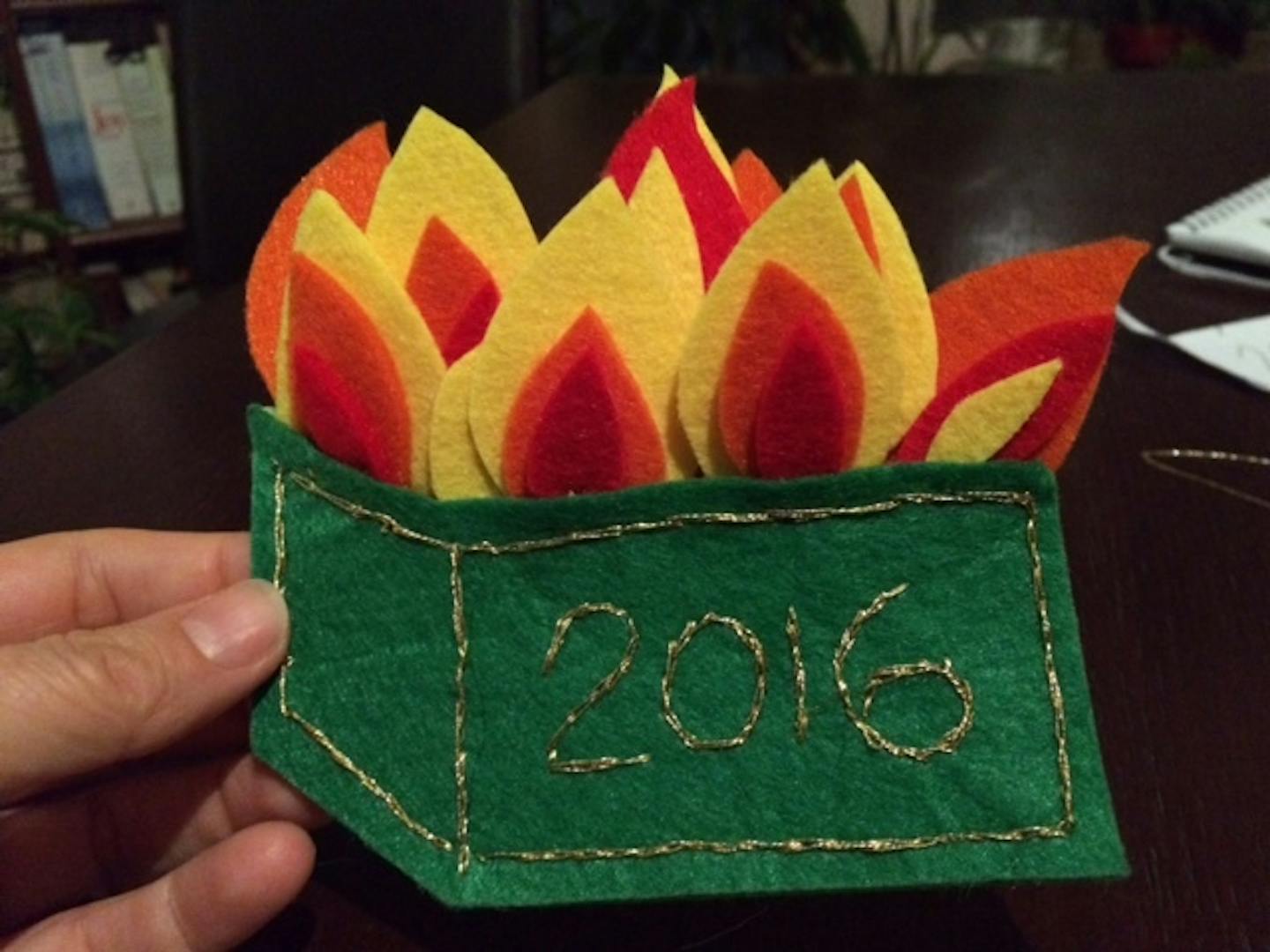 Part of step-by-step instructions for crafting a felt dumpster fire holiday ornament.