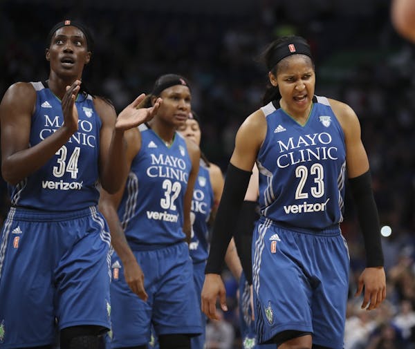 The Lynx' Sylvia Fowles (34), Rebekkah Brunson (32), and Maya Moore (23) headed to the bench late in the fourth quarter.