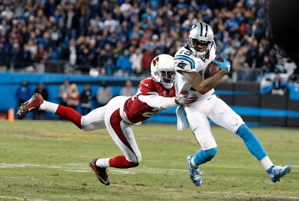 Panthers wide receiver Ted Ginn got past the Cardinals' Justin Bethel for a touchdown run during the first half Sunday.