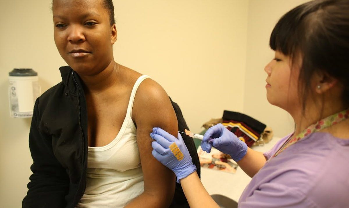 Denisha Young, 17, of St. Paul, received the flu vaccine administered by registered nurse Sherry Vang.