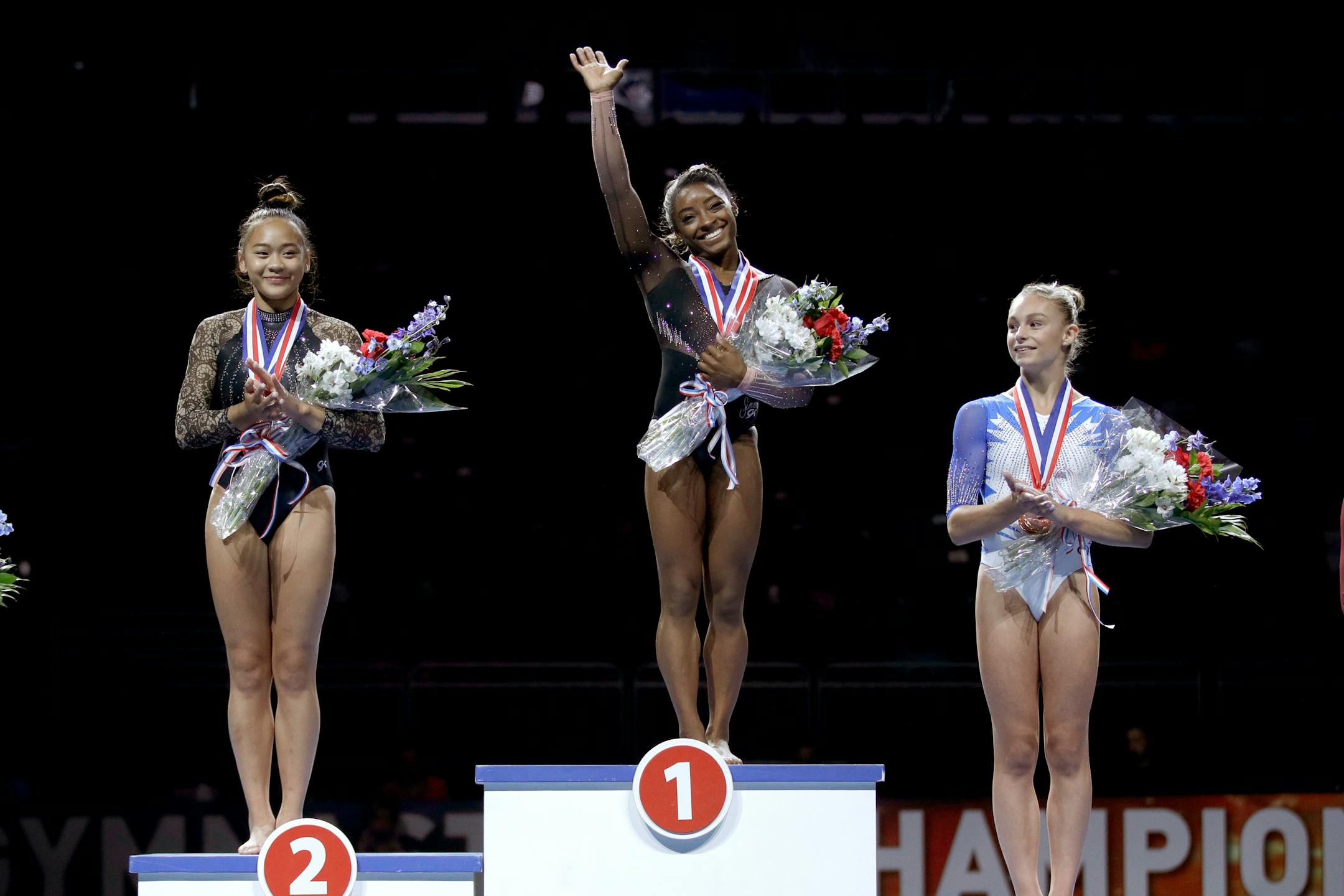 All-around winner Simone Biles, center, stands on the podium with second place finisher Sunisa Lee, left, and third place finisher Grace McCallum after the senior women's competition at the 2019 U.S. Gymnastics Championships Sunday, Aug. 11, 2019, in Kansas City, Mo.