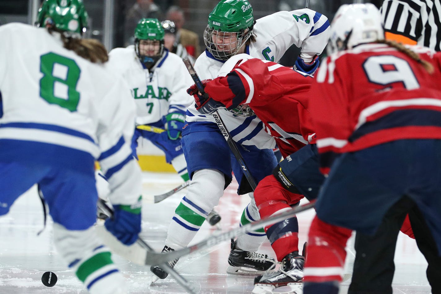 The Blake School's Lucy Burton (3) fought for the puck during a face off in the first period. ] ANTHONY SOUFFLE &#xef; anthony.souffle@startribune.com Players competed in the Class 2A girls' hockey state championship Saturday, Feb. 25, 2017 at the Xcel Energy Center in St. Paul, Minn.