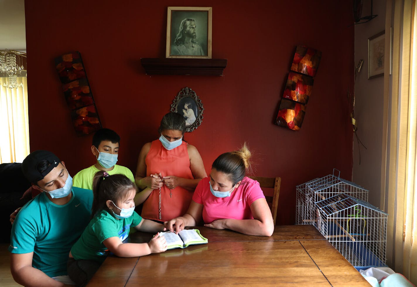 Mejia took time to pray with her family before heading to work a double shift at the Jennie-O plant in Willmar.