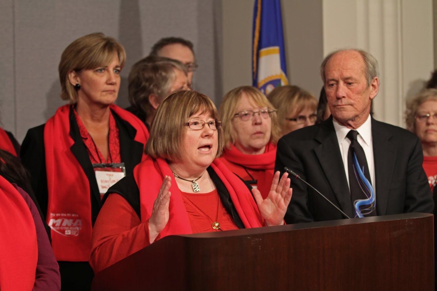 (left to right) Minnesota Nurses Association President Linda Hamilton, RN, Rep. Larry Howes and Sen. Jeff Hayden (not pictured) announced the introduction of legislation aimed at addressing patient safety through adequate staffing levels at Minnesota hospitals. Behind the trio were nurses and members of the Minnesota Nurses Association attending the news conference at the State Office Building on February 28, 2012