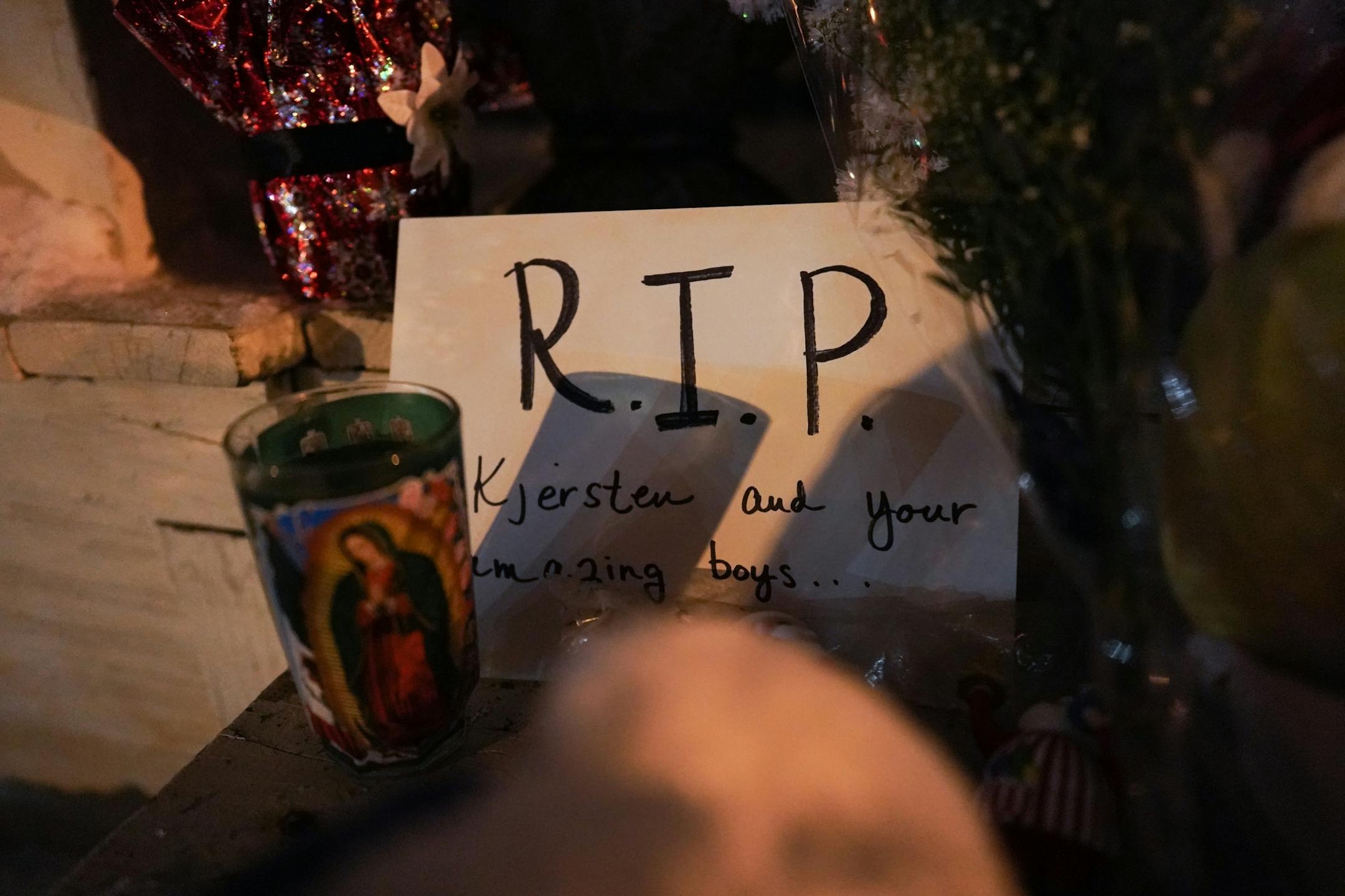 Mourners visit a vigil for slain Schladetzky family members at their home on Oakland Ave. South.