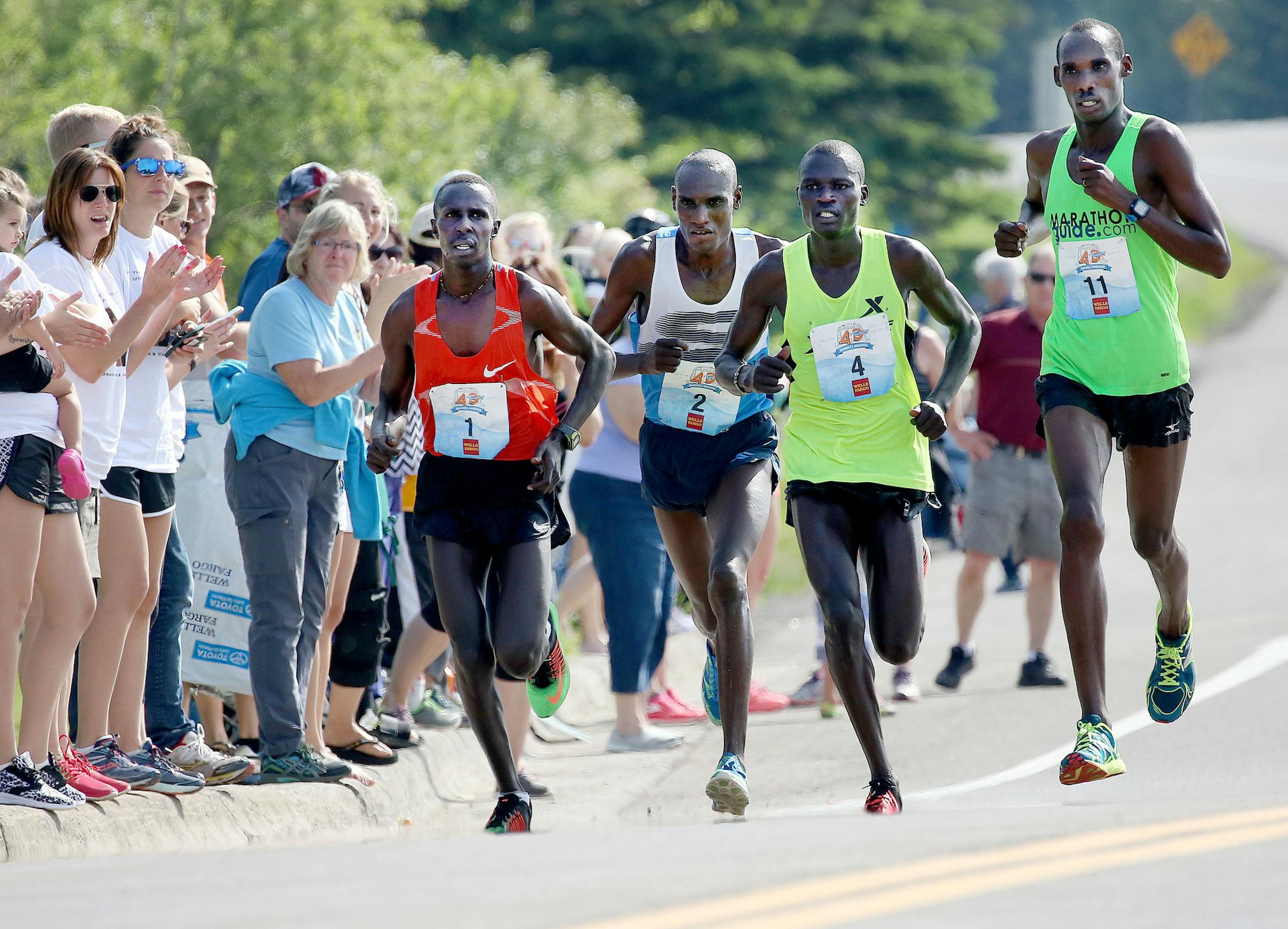 t6.18.16 Bob King -- kingRACE0619c26 - The Grandmas Marathon elite pack passes the crowd near the Lester River bridge on London Road. From left: Elisha Barno, Weldon Kirui, Jacob Chemtai and Kimutai Cheruiyot. Bob King / rking@duluthnews.com
