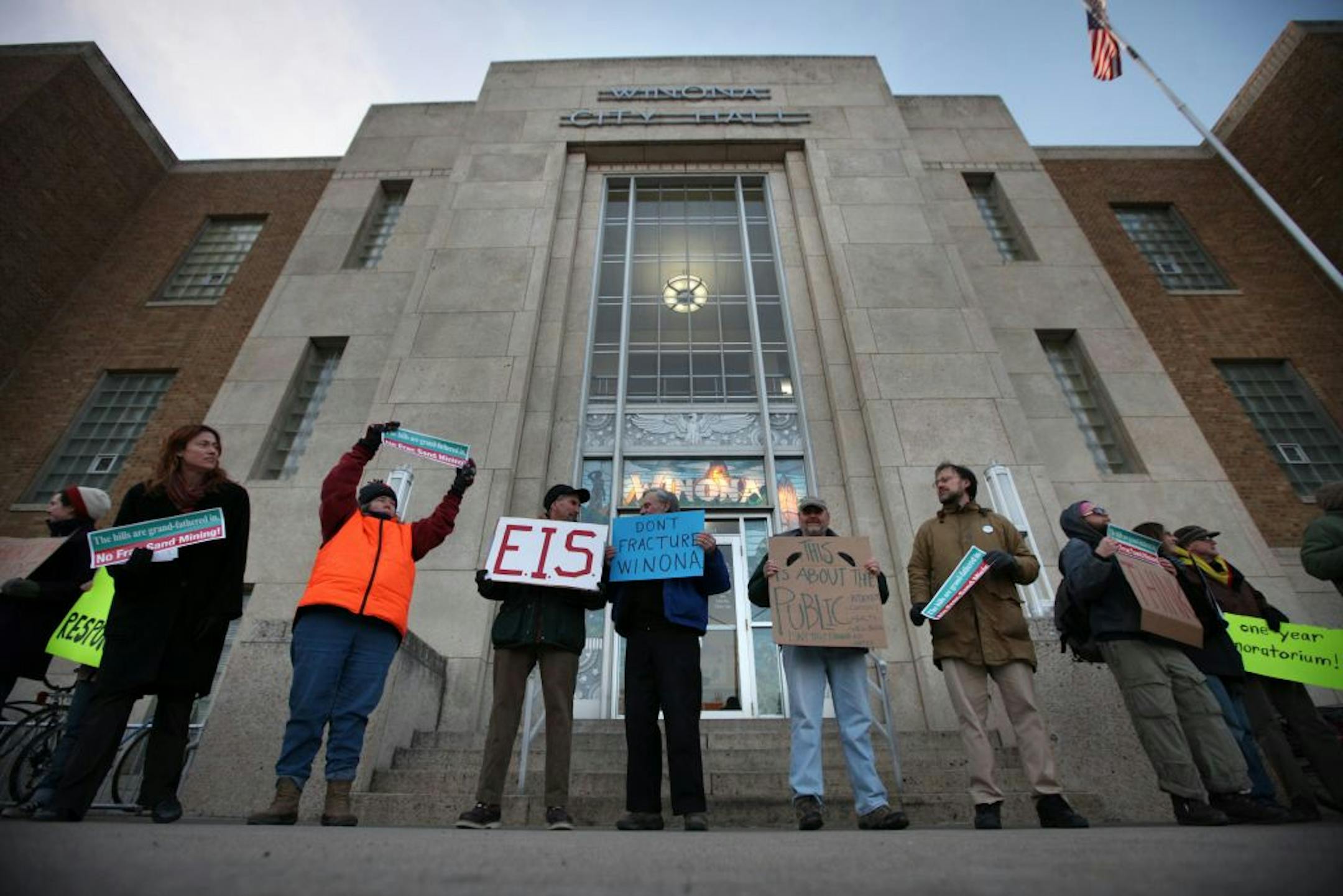 Nowhere are the concerns about sand mining, and expectations for its economic potential, more palpable than in the town of Winona. It's also becoming a lesson in how communities cope with a new industry that is booming in lock step with the business it supplies – the controversial oil and gas drilling practice called hydro fracking. (IN THIS PHOTO) Protesters, seeking a moratorium on increased frac sand mining in the area, greeted city council members outside Winona City Hall Monday evening befo