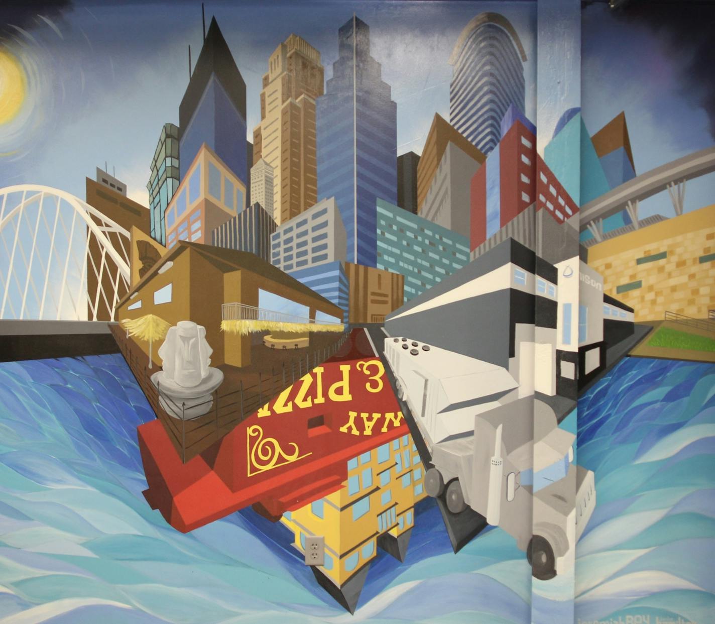 Artists Jeremiah Beh and Jordan Hamilton, working through Juxtoposition Arts of North Minneapolis, painted a mural for Unisys Comfort's offices that includes the Minneapolis skyline, the Unison plant, and landmarks Lowry Avenue Bridge, Psycho Suzies, Target Field, and Broadway Pizza's caboose.