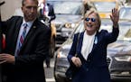 Democratic presidential candidate Hillary Clinton waves as she walks from her daughter's apartment building Sunday, Sept. 11, 2016, in New York. Clint