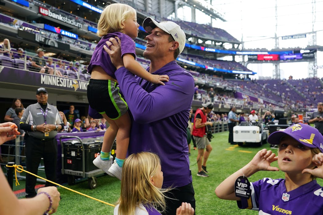 Kevin O'Connell greets his children - Kolten (held by O'Connell), Kaden, right; and Quinn -- before the Vikings' preseason game against the 49ers on Aug. 20.