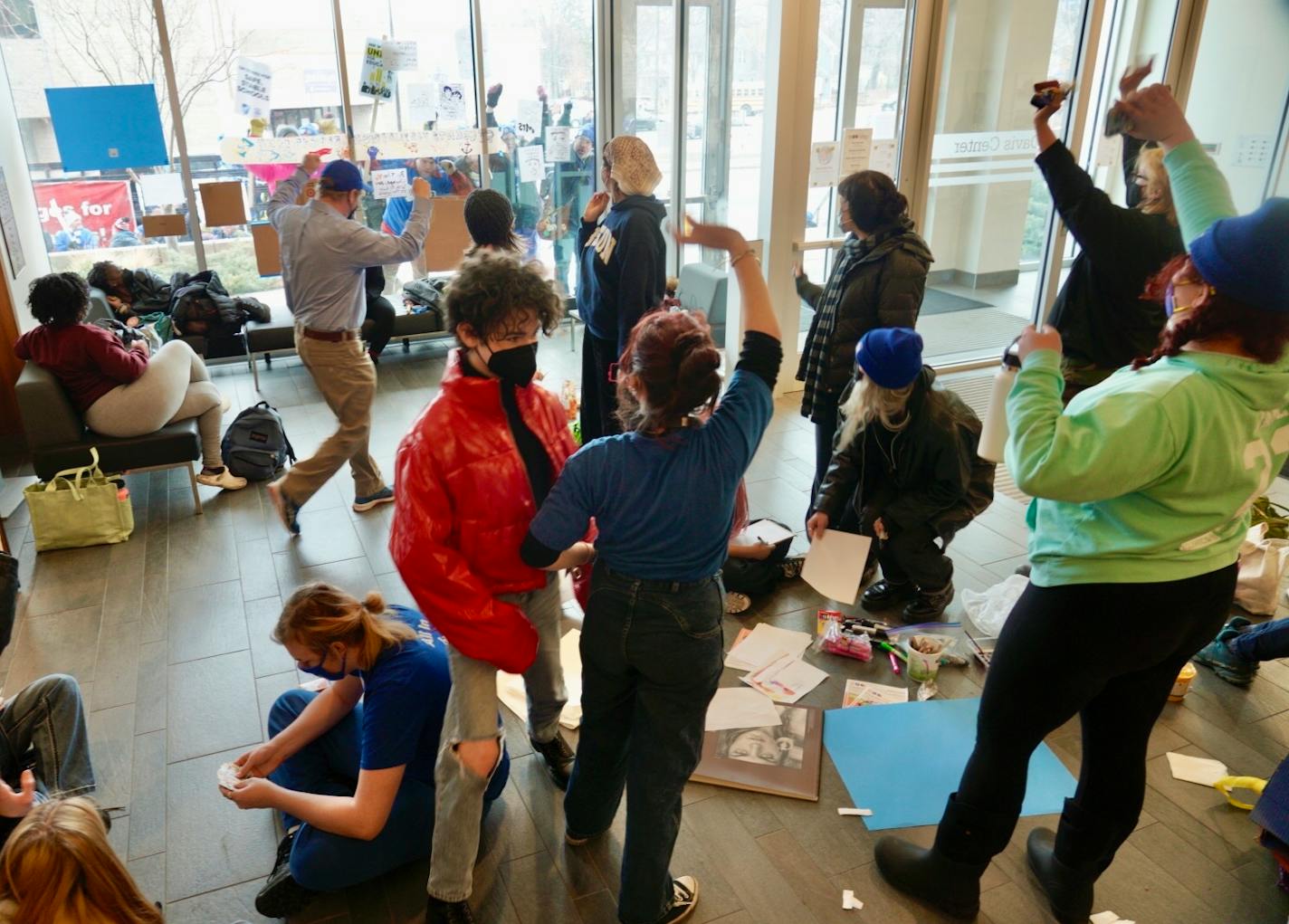 Students camped out in the lobby of the John B. Davis Education Service Center, waving to protesting teachers and support staff picketing on the street out front Wednesdayy evening. (Brian Peterson/Star Tribune)