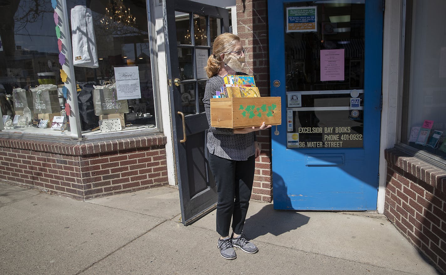 Ann Woodbeck, owner of Excelsior Bay Books brought out a selection of books for customers to look through on a bench outside the store.