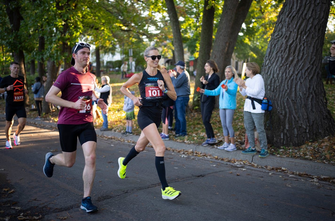 Former Olympian Carrie Tollefson, wearing bib No. 101, ran on E. Lake Harriet Parkway with Ben Kampf of Minneapolis, wearing bib No. 26. Tollefson was eighth among women and was the first masters woman to cross the finish line. ] JEFF WHEELER • jeff.wheeler@startribune.com