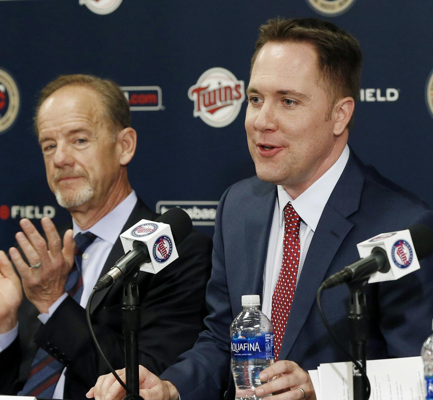 Minnesota Twins owner, Jim Pohlad, left, and new general manager Tad Levine, right, applaud the introduction of new chief baseball officer Derek Falvey, center, during introductions Monday, Nov. 7, 2016 in Minneapolis. (AP Photo/Jim Mone)