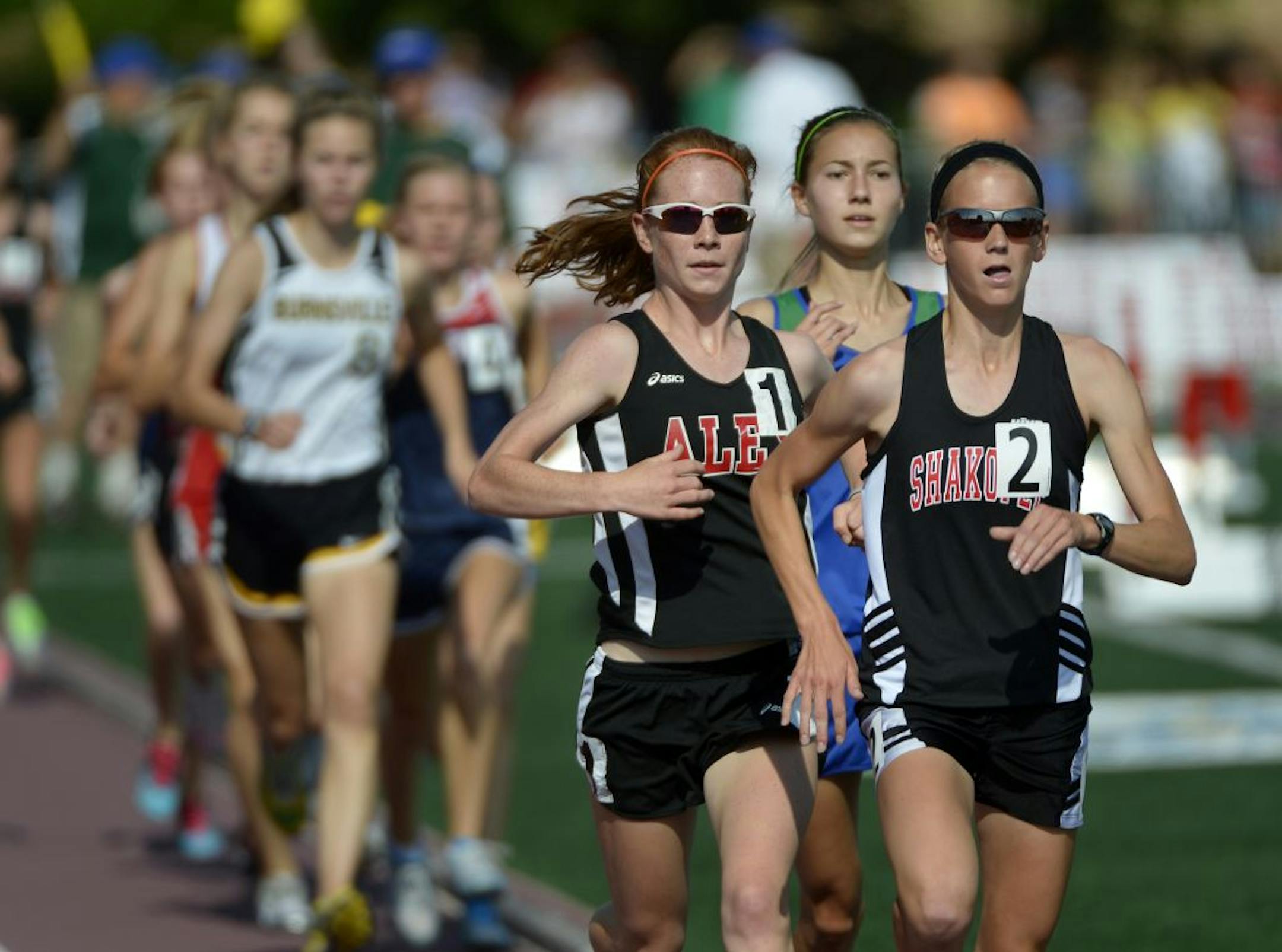 Boy's and Girl's State High School Track Meet. (IN THIS PHOTO) Defending champion Jamie Piepenburg of Alexandria (#1) and Maria Hauger of Shakopee (#2) battle it out in the Girls Class AA 3200 Meter run. Hauger won the race and Piepenburg came in 3rd. Eagan's Danielle Anderson (center) took 2nd, Friday morning at Hamline University.