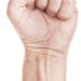 Labor movement, workers union strike concept with male fist isolated on white background raised in the air fighting for their rights.