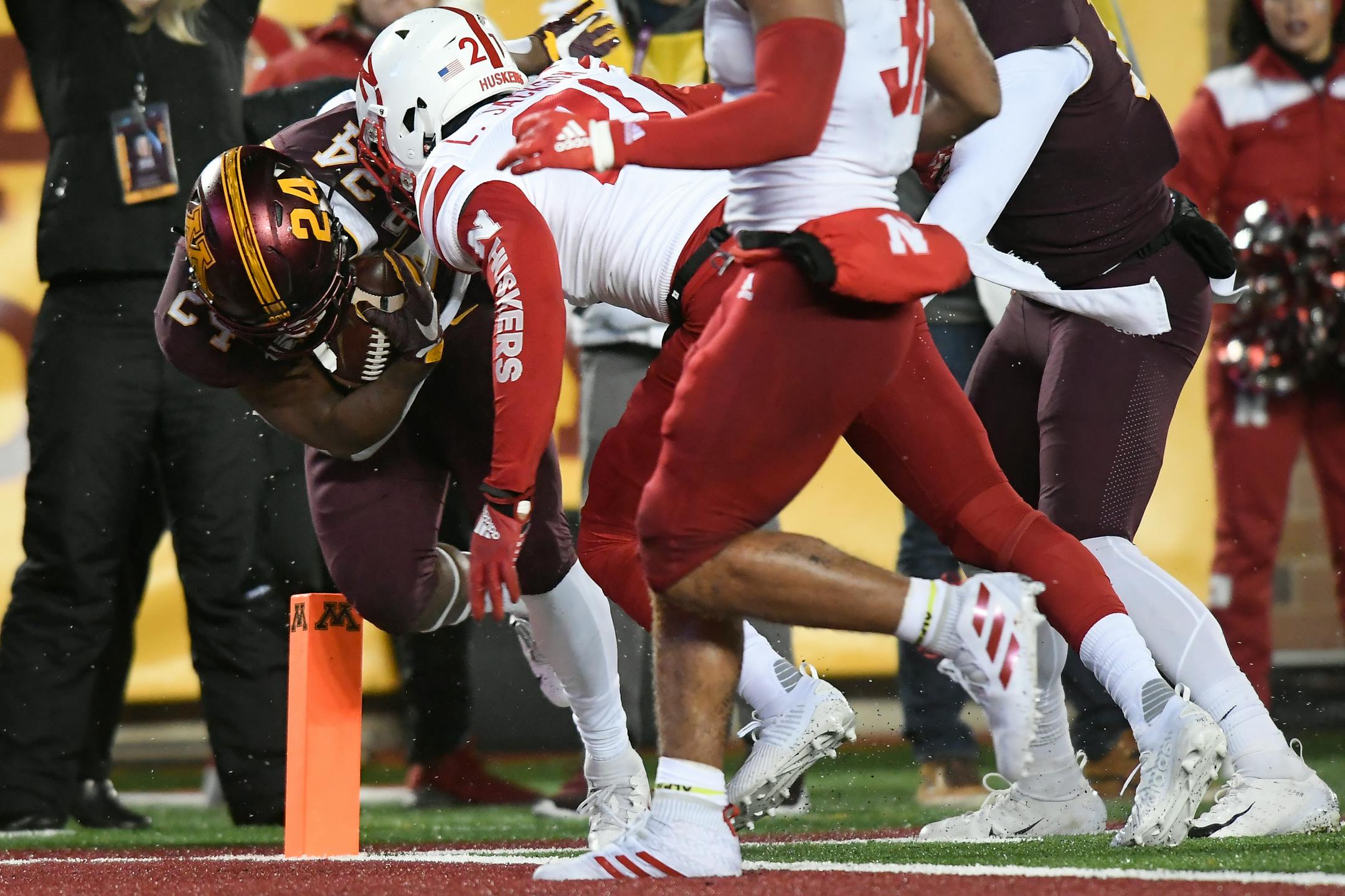 Gophers running back Mohamed Ibrahim barreled into the end zone for a second-quarter touchdown despite the efforts of Cornhuskers cornerback Lamar Jackson (21) to stop him.