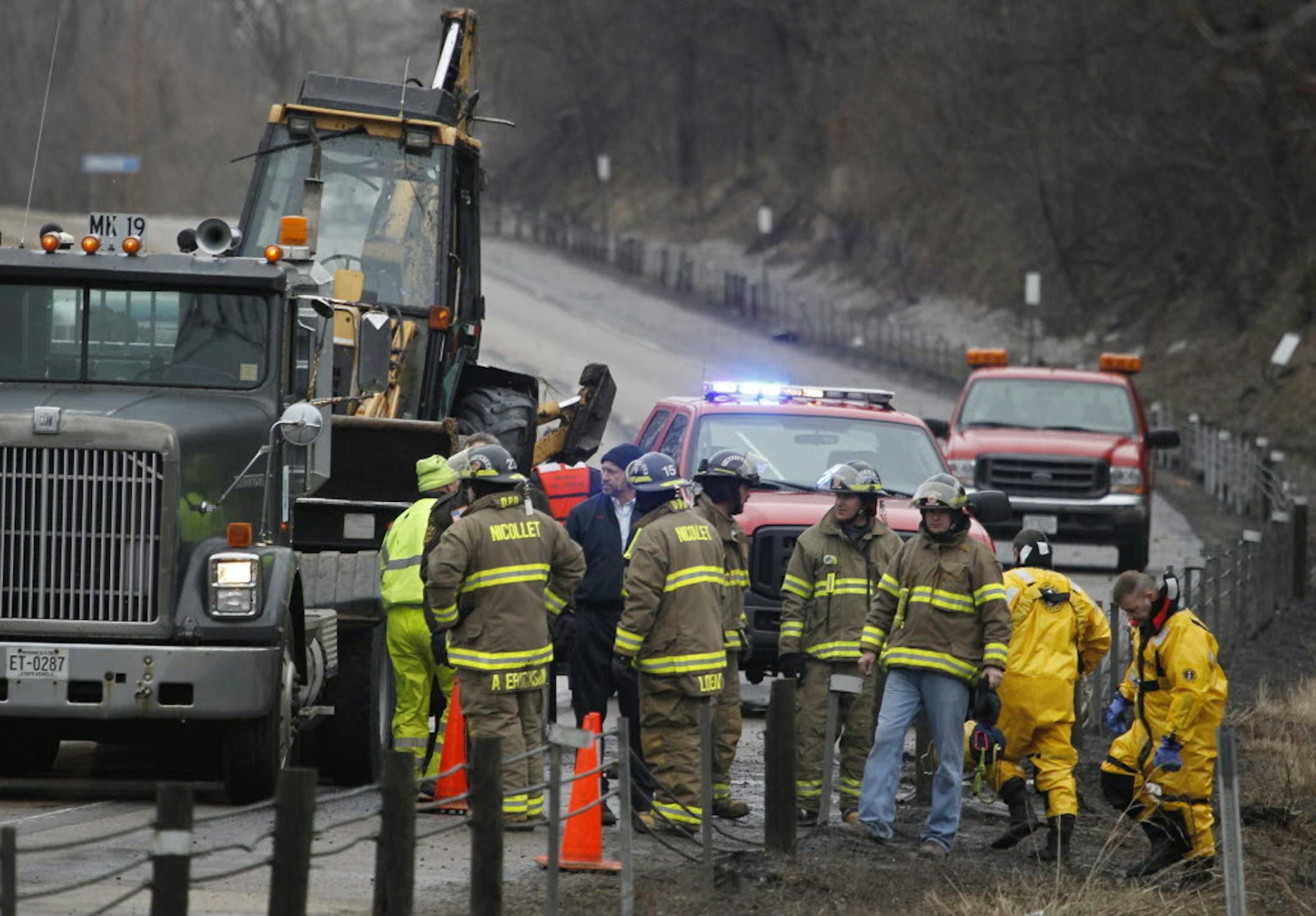 Emergency workers searched for a MnDOT backhoe driver, later identified as Michael J. Struck, 39, of Cleveland, Minn., who was swept into the Minnesota River between St. Peter and Mankato on Tuesday.