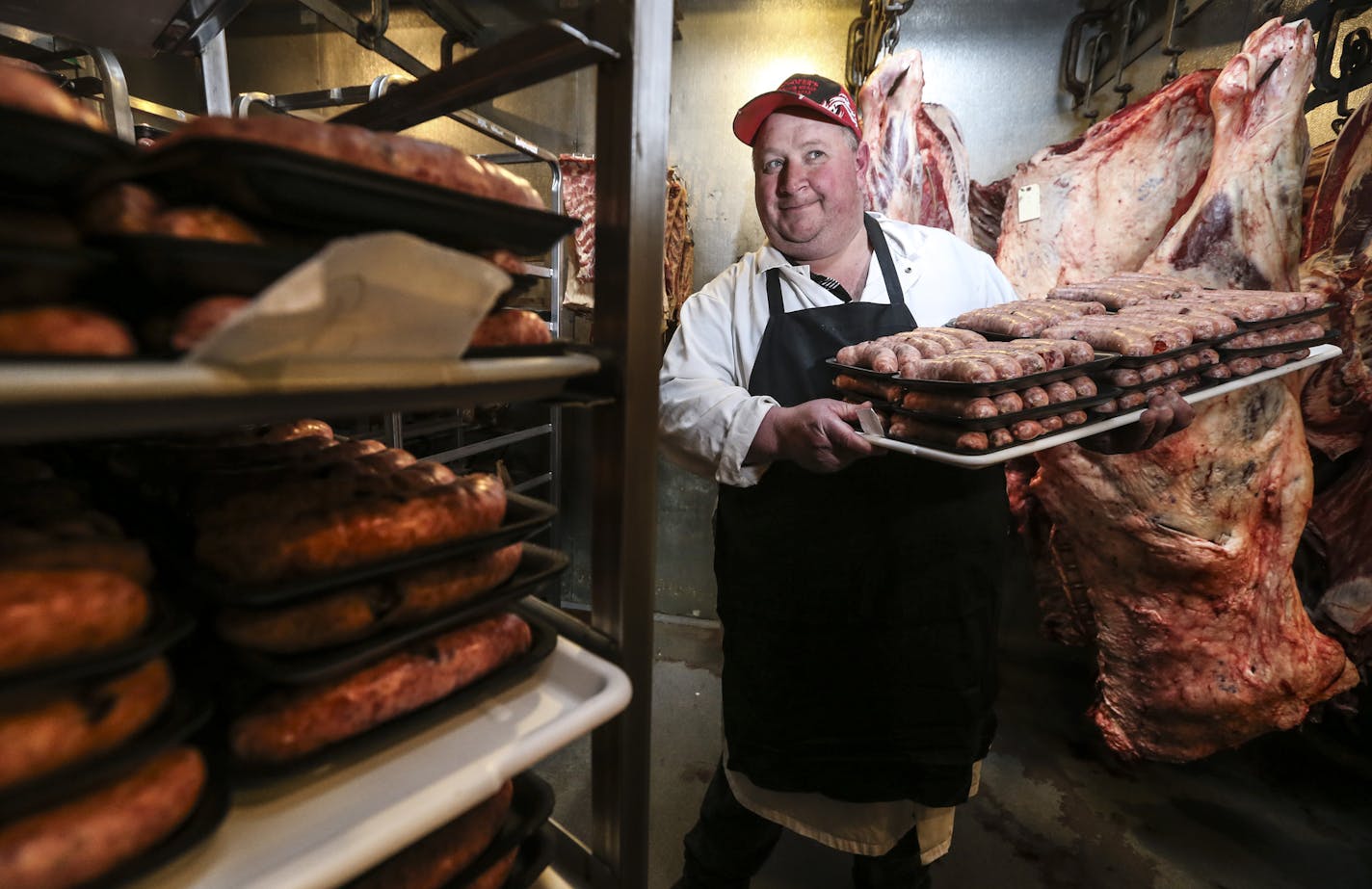 Spencer Gundhofer held a platter of his famous gummy bear brats at Gundhofer's Old-Fashion Meats in Hugo, Minn. on Tuesday, July 1, 2014. ] RENEE JONES SCHNEIDER &#x2022; reneejones@startribune.com