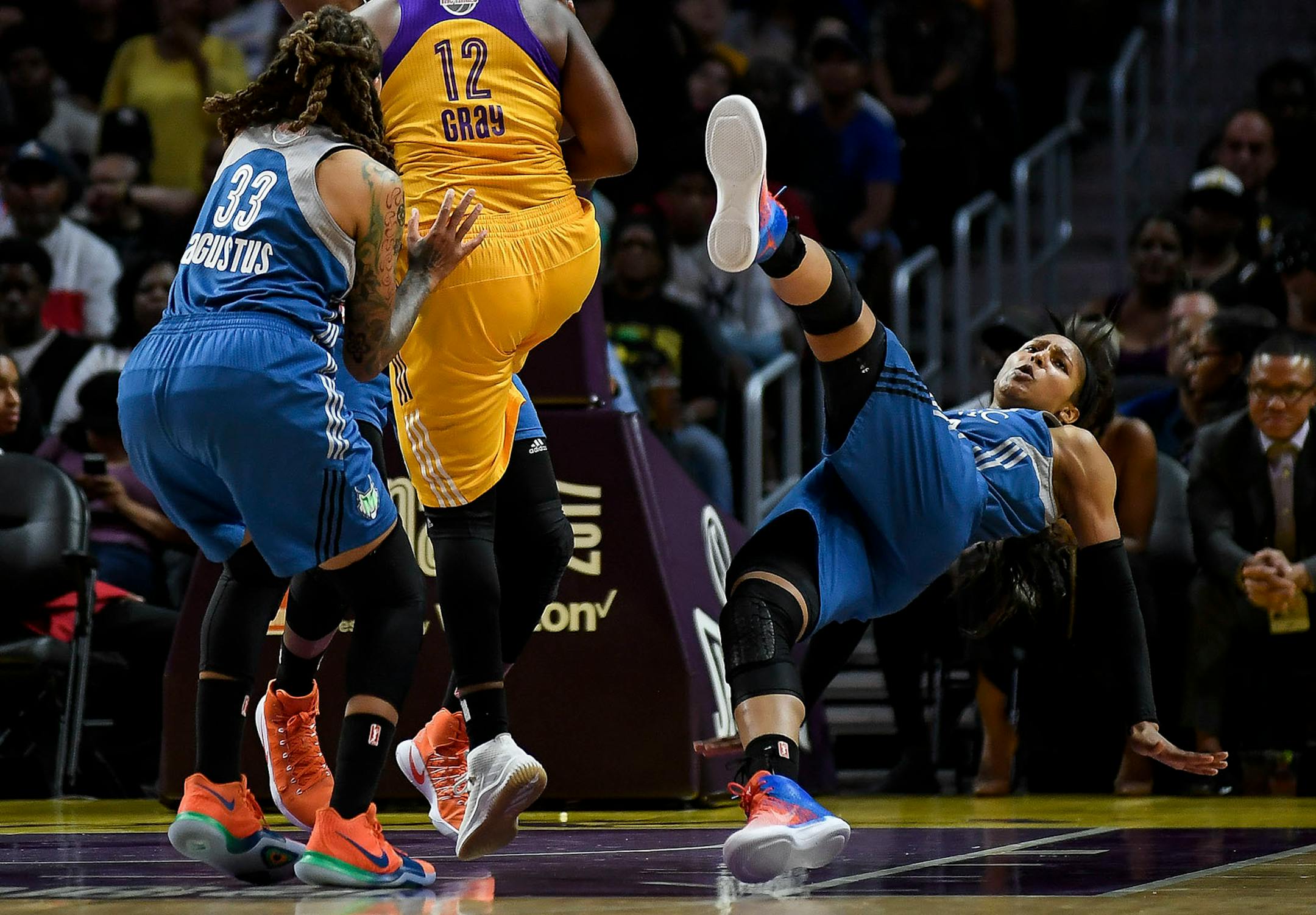 Minnesota Lynx forward Maya Moore (23) was knocked off her feet and called for a blocking foul in the first half after coming into hard contact with Los Angeles Sparks guard Chelsea Gray (12).