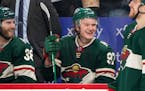 Minnesota Wild left wing Kirill Kaprizov (97) smiles as the announcement is made that he recorded his 100th point of the season in the second period F