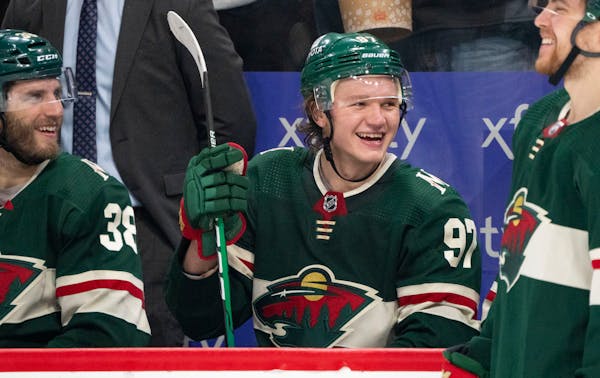 Minnesota Wild left wing Kirill Kaprizov (97) smiles as the announcement is made that he recorded his 100th point of the season in the second period F
