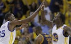 Golden State Warriors forward Kevin Durant (35) and forward Draymond Green (23) celebrate during the second half of Game 1 of basketball's NBA Finals 