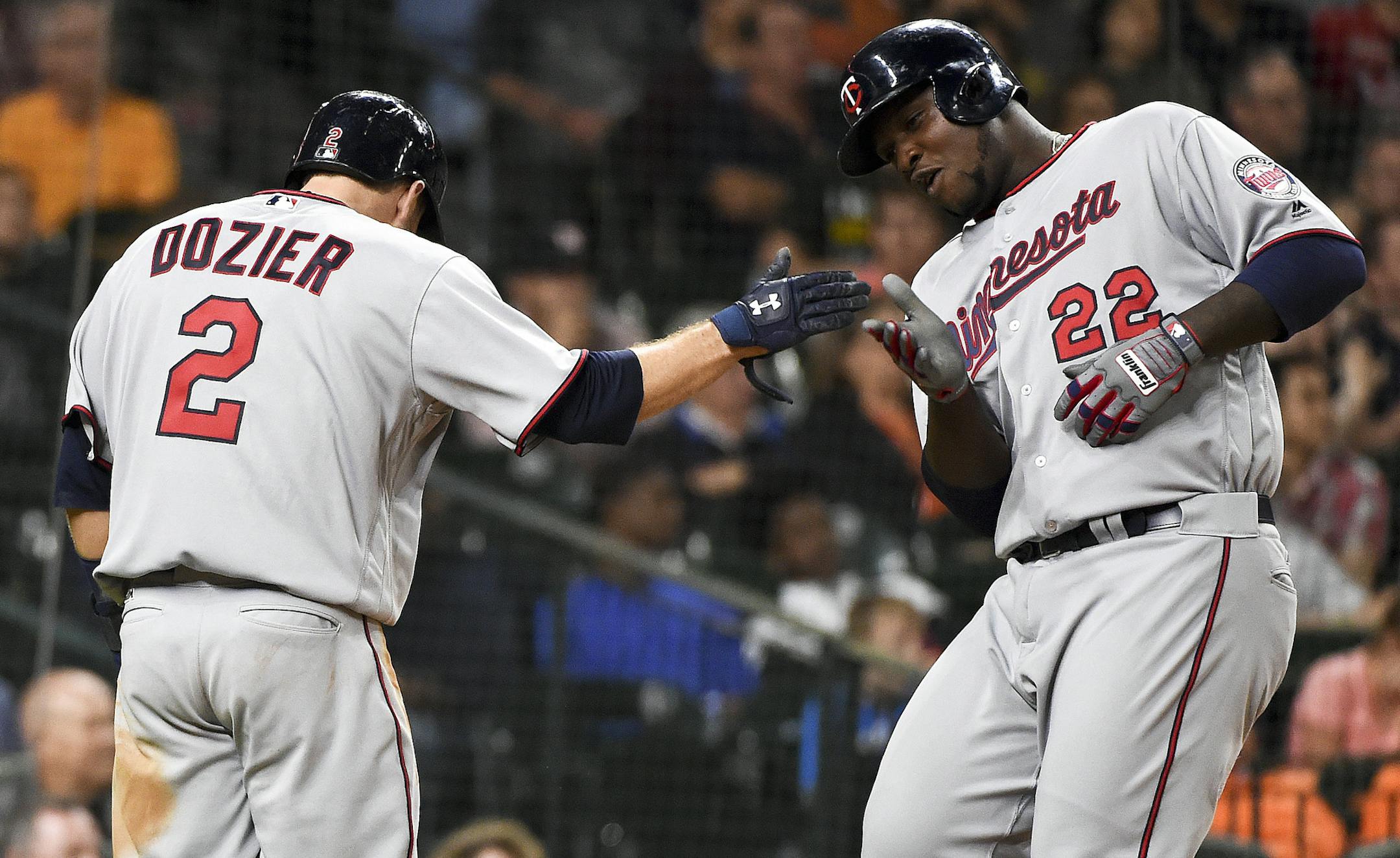 Minnesota Twins' Miguel Sano (22) and Brian Dozier (2) celebrate their runs scored off of a two-run triple by Byung Ho Park in the fifth inning of a baseball game against the Houston Astros, Monday, May 2, 2016, in Houston. (AP Photo/Eric Christian Smith)