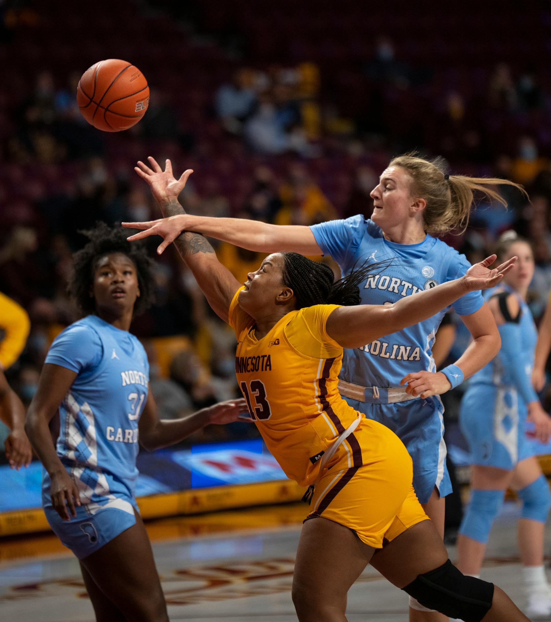 Minnesota Gophers guard Gadiva Hubbard (13) scored late in the third quarter despite the defense of North Carolina Tar Heels guard Alyssa Ustby (1) Wednesday, Dec. 1, 2021 at Williams Arena in Minneapolis. The University of Minnesota women's basketball team lost to the University of North Carolina 82-76 in an NCAA basketball game Wednesday, Dec. 1, 2021 night at Williams Arena in Minneapolis. ] JEFF WHEELER • Jeff.Wheeler@startribune.com