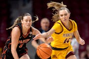 Pacific's Kadie Deaton and the Gophers' Mara Braun chase a loose ball in the first quarter Tuesday at Williams Arena.