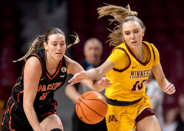 Pacific's Kadie Deaton and the Gophers' Mara Braun chase a loose ball in the first quarter Tuesday at Williams Arena.