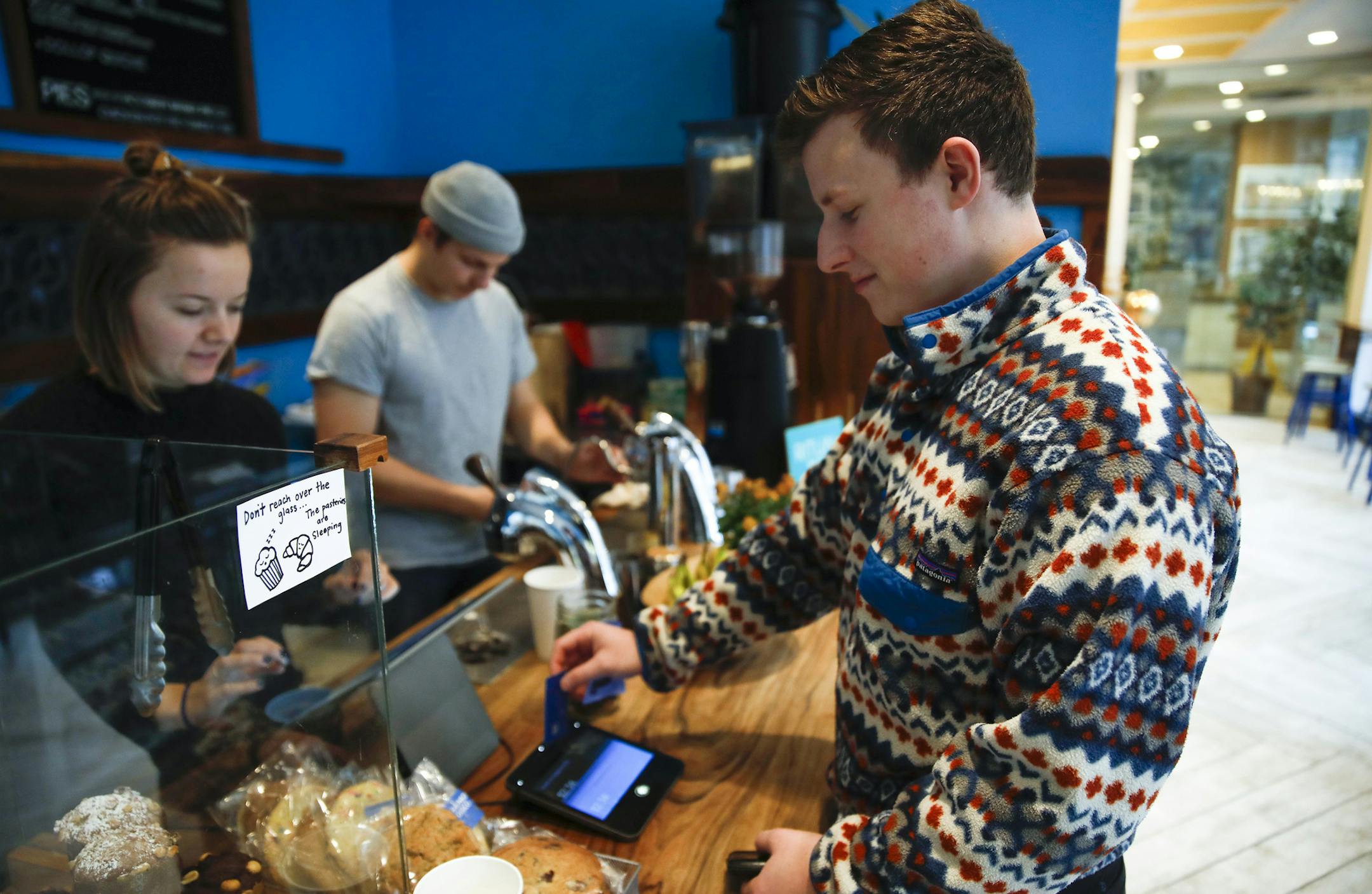 Eli Gitelman uses the technology to check out and add a tip at a Dollop coffee shop in the Streeterville neighborhood in Chicago (860 N. Dewitt Place) on Thursday, Nov. 29, 2018. The story is about how technology is transforming tipping, perhaps most evident when people swipe their credit cards at coffee shops and are confronted with a tip screen prompting them to add a tip for a service they may not have considered tipping for before. (Jose M. Osorio/Chicago Tribune) ORG XMIT: 1251144