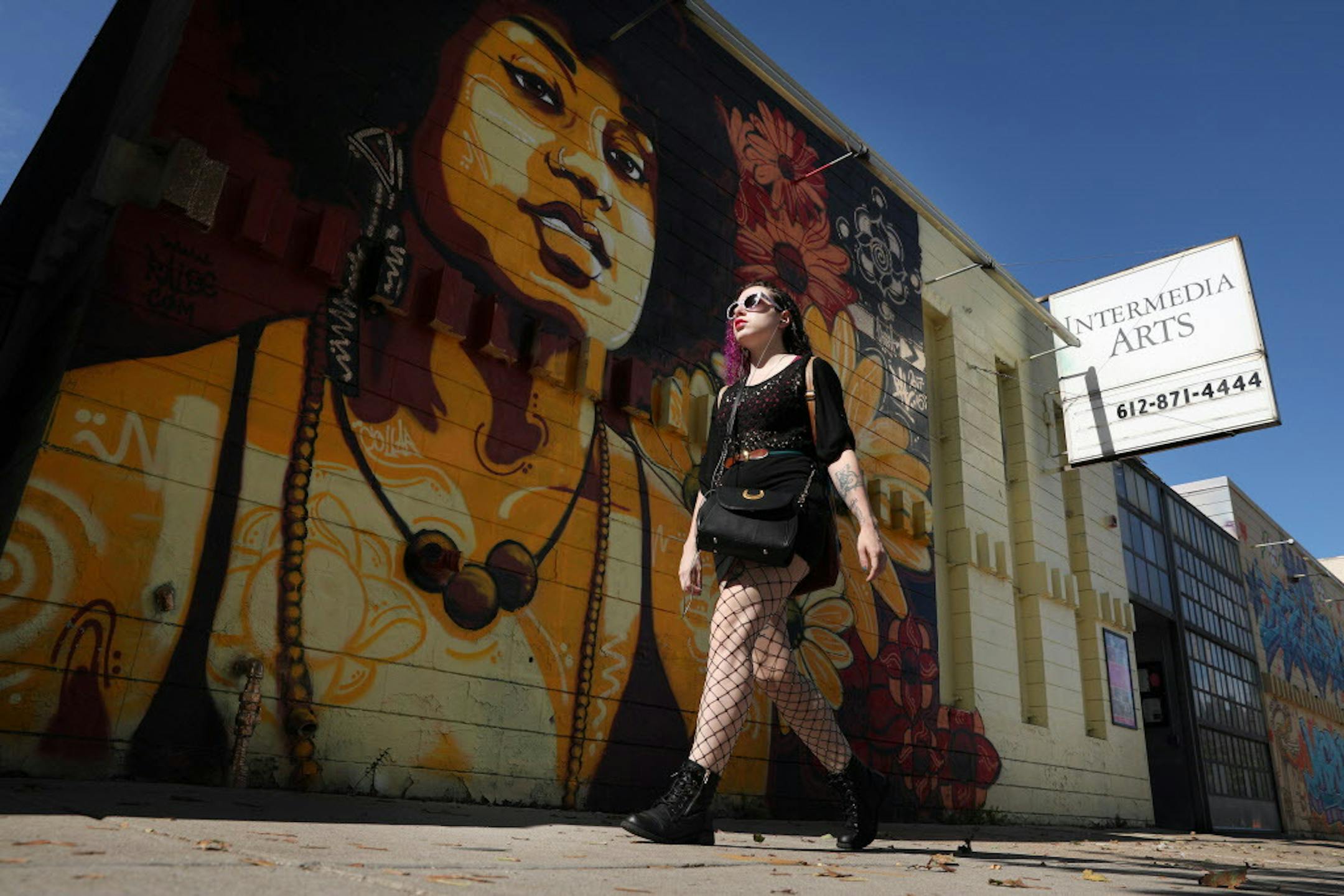 A pedestrian walked past one of the murals that adorns the outside of the Intermedia Arts building Thursday. ] ANTHONY SOUFFLE &#xef; anthony.souffle@startribune.com Intermedia Arts, the Minneapolis theater and gallery space that has long been a mainstay of the arts community, is freezing operations temporarily as it confronts a financial crisis. The venue will reduce its staff by 80 percent and operate on a skeletal basis over the next 90 days. In that time, Intermedia will consider its options