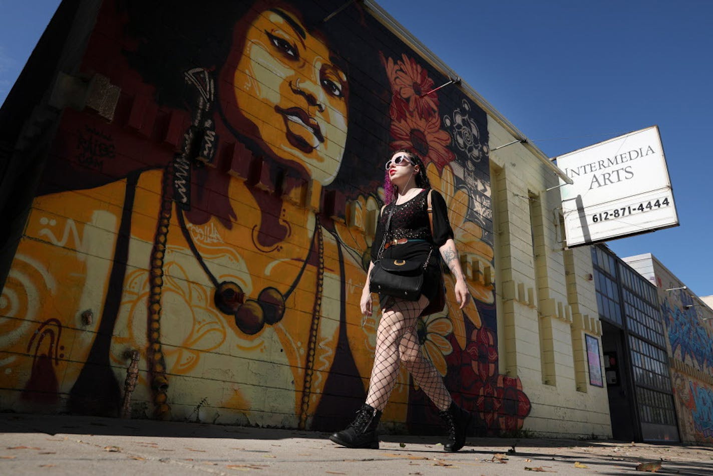 A pedestrian walked past one of the murals that adorns the outside of the Intermedia Arts building Thursday. ] ANTHONY SOUFFLE &#xef; anthony.souffle@startribune.com Intermedia Arts, the Minneapolis theater and gallery space that has long been a mainstay of the arts community, is freezing operations temporarily as it confronts a financial crisis. The venue will reduce its staff by 80 percent and operate on a skeletal basis over the next 90 days. In that time, Intermedia will consider its options