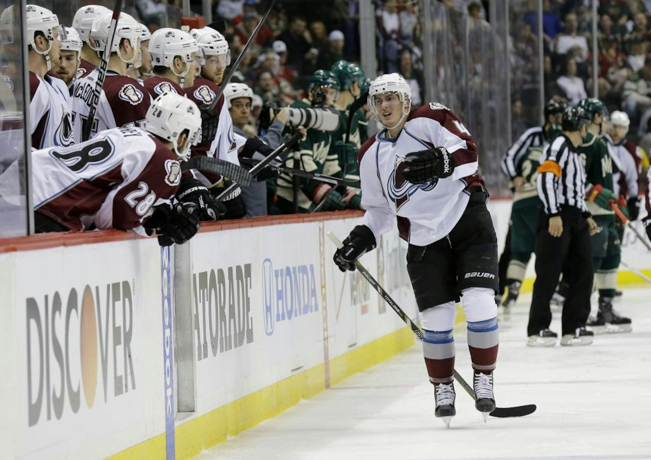 Colorado Avalanche defenseman Tyson Barrie, right, leaves the ice after getting injured on a hit by Minnesota Wild left wing Matt Cooke during the second period of Game 3 of an NHL hockey first-round playoff series in St. Paul, Minn., Monday, April 21, 2014. The Wild won 1-0 in overtime.